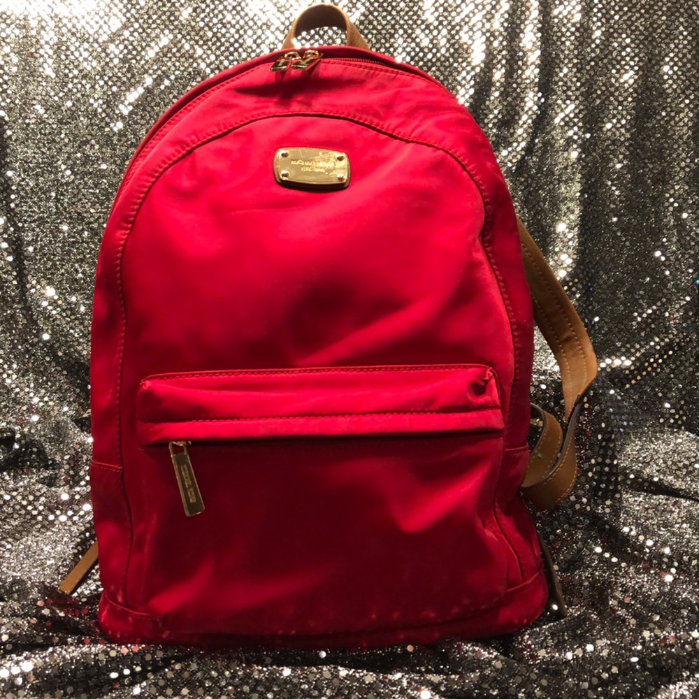 Michael Kors firetruck red backpack.